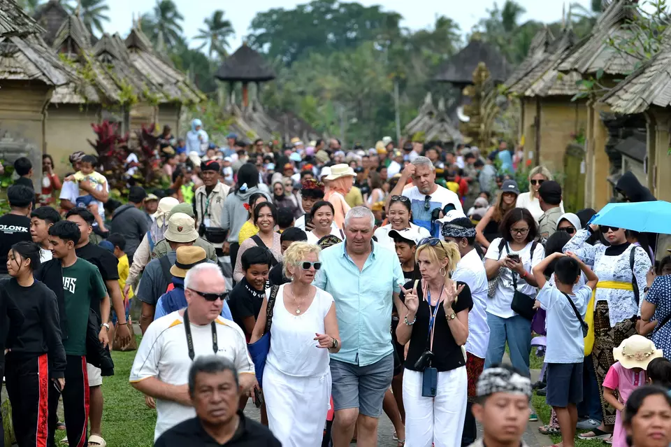 Foreigners visit traditional houses in Bali