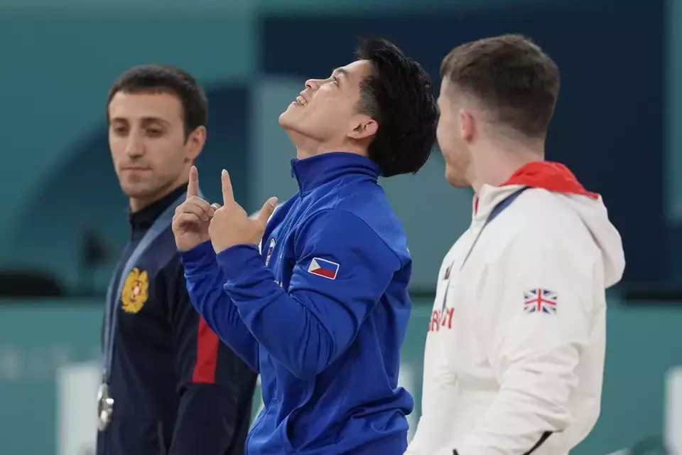 Filippino gymnast Carlos Edriel Yulo, center, celebrates during the medal ceremony for the artistic gymnastics individual vault finals at Bercy Arena at the 2024 Summer Olympics, Sunday, Aug. 4, 2024, in Paris, France.(AP Photo/Abbie Parr)