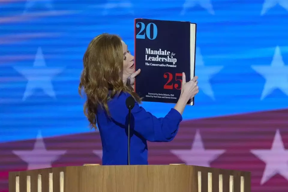 Michigan State Senator Mallory McMorrow holding up a book during her remarks at the Democratic National Convention on Monday, Aug. 19, 2024, in Chicago. (AP Photo/J. Scott Applewhite)