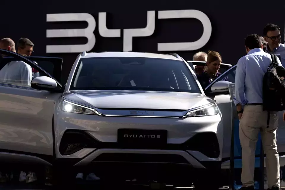 Visitors look at the Chinese made BYD ATTO 3 at the IAA motor show in Munich, Germany, on Sept. 8, 2023. (AP Photo/Matthias Schrader)
