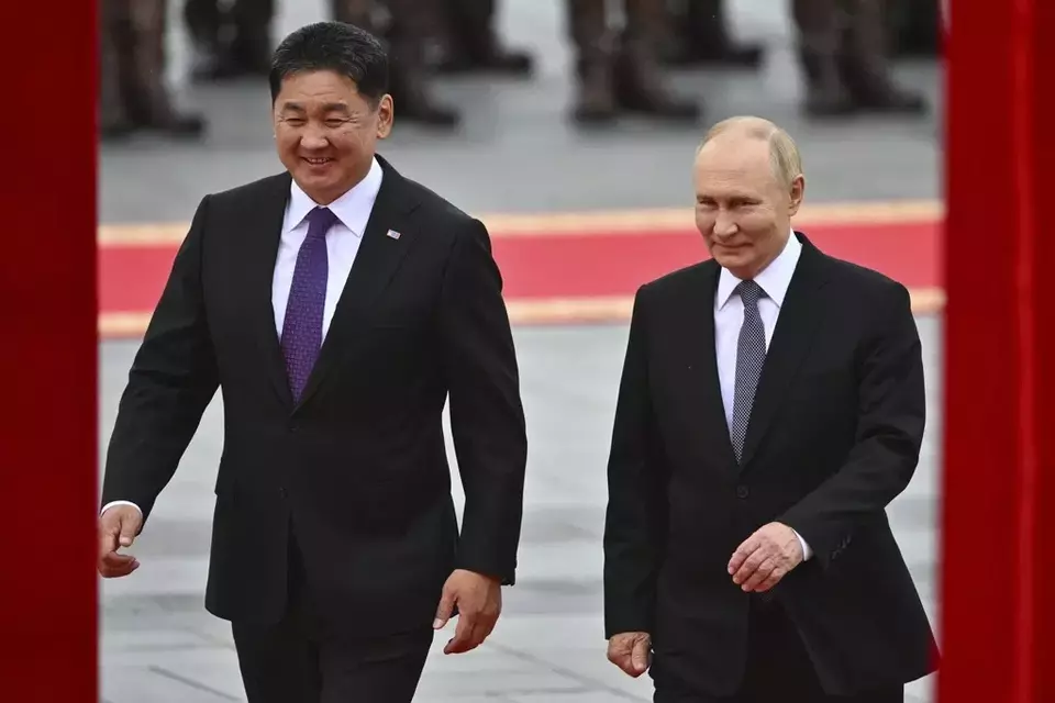 Russian President Vladimir Putin, right, walks with Mongolian President Ukhnaagiin Khurelsukh, left, during welcoming ceremony at Sukhbaatar Square in Ulaanbaatar, Mongolia, Tuesday, Sept. 3, 2024. (Kristina Kormilitsyna, Sputnik, Kremlin Pool Photo via AP)