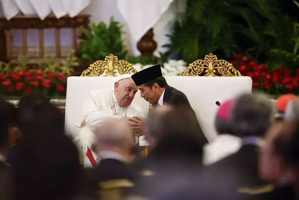Pope Francis, left, and President Joko Widodo hold hands during a meeting with Indonesian authorities, civil society and the diplomatic corps, during his apostolic visit to Asia, at the Presidential Palace in Jakarta Wednesday, Sept. 4, 2024. (Willy Kurniawan/Pool Photo via AP)
