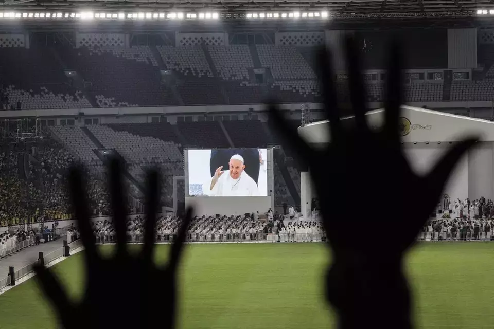 Catholic faithful attend a holy mass led by Pope Francis, shown on the screen, at the Gelora Bung Karno Stadium, in Jakarta, Thursday, Sept. 5, 2024. (Yasuyoshi Chiba/Pool Photo via AP)