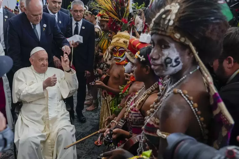 Pope Francis meets performers outside the APEC Haus in Port Moresby, Saturday, Sept. 7, 2024, where Pope Francis and Papua New Guinea's Governor General Bob Dadae attended a traditional dance performance. As a second leg of his 11-day trip to Asia and Oceania Pope Francis's visit to Papua New Guinea will take him to a remote part of the South Pacific island nation where Christianity is a recent addition to traditional spiritual beliefs developed over millennia. (AP Photo/Gregorio Borgia)