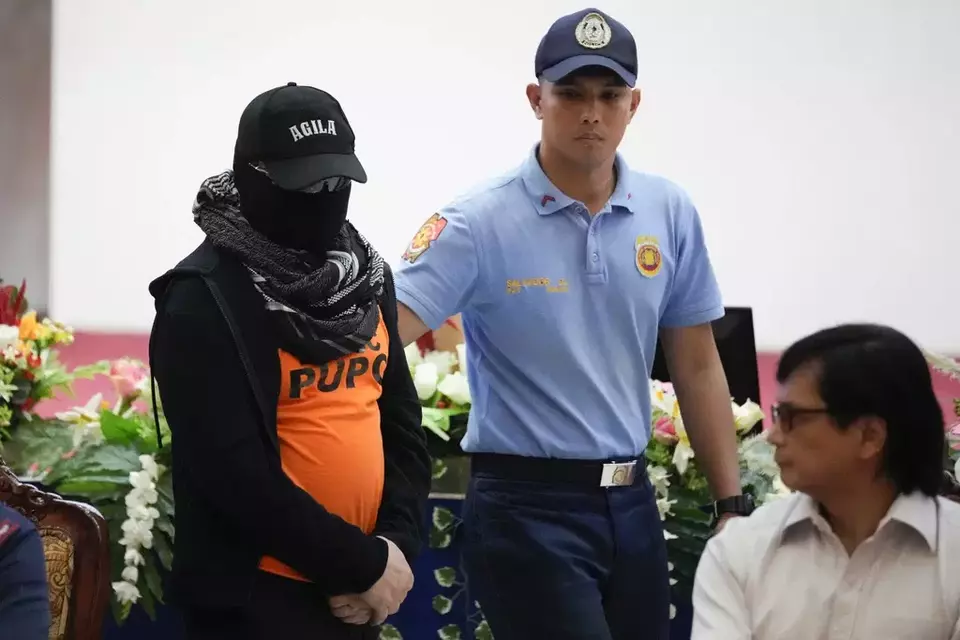 Apollo Quiboloy, center, a Filipino preacher accused of sexual abuse and human trafficking in the Philippines and similar charges in the United States, is escorted beside Philippine Secretary of Interior and Local Government Benhur Abalos, left, during a press conference at the Camp Crame police headquarters in Quezon City, Philippines Monday, Sept. 9, 2024. (AP Photo/Aaron Favila)