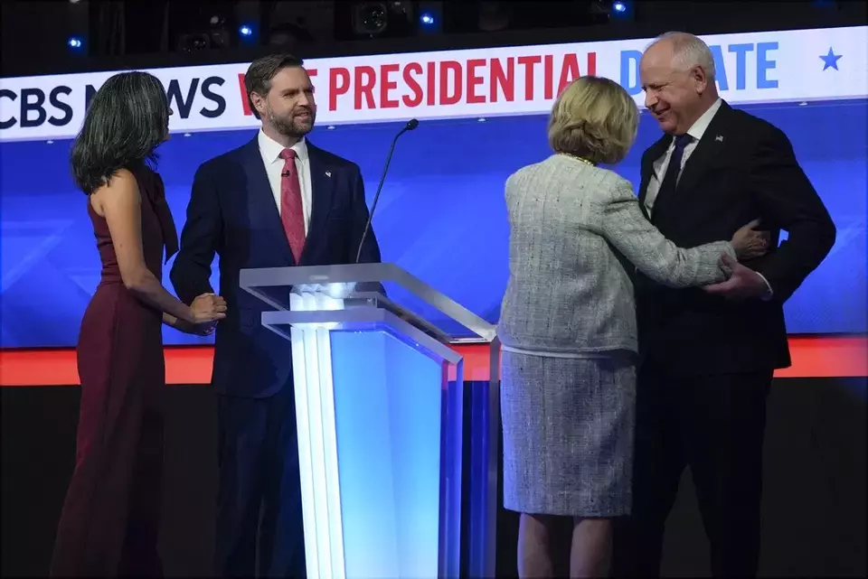 Republican vice presidential nominee Sen. JD Vance, R-Ohio, and his wife Usha Vance and Democratic vice presidential candidate Minnesota Gov. Tim Walz and his wife Gwen Walz stand on stage after the vice presidential debate hosted by CBS News, Tuesday, Oct. 1, 2024, in New York. (AP Photo/Matt Rourke)