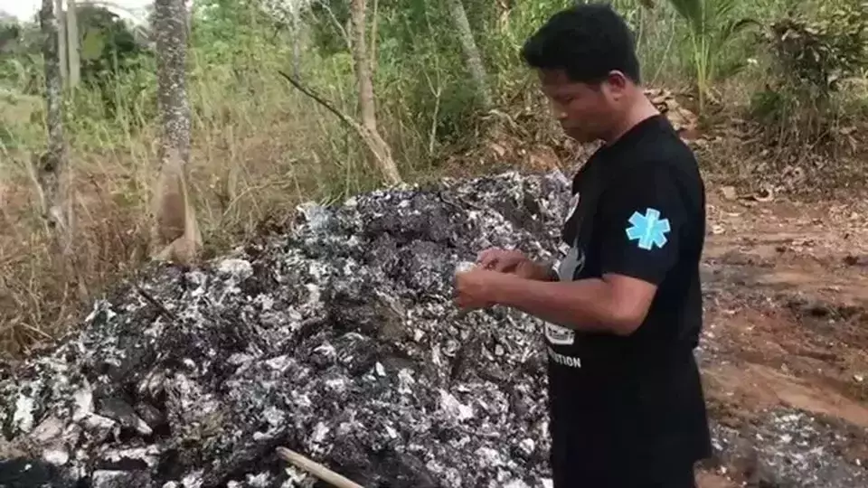 A man inspects pharmaceutical waste illegally burned in residential area in Jepara. Central Java, Thursday, Oct. 3, 2024. (B-Universe Photo/Jamaah)