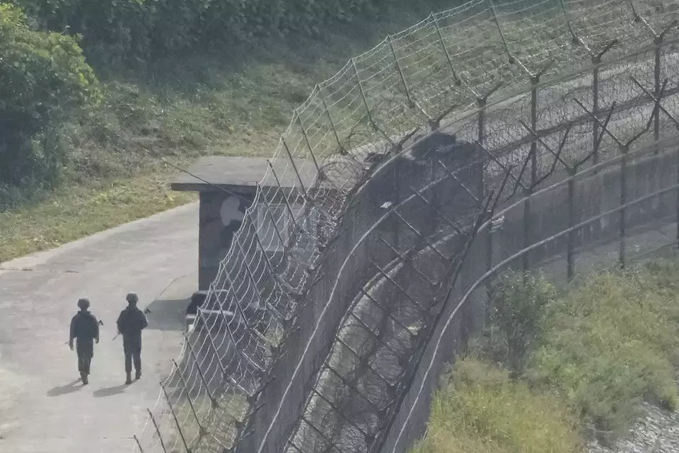 South Korean army soldiers patrol along the barbed-wire fence in Paju, South Korea, near the border with North Korea, Thursday, Oct. 10, 2024. (AP Photo/Ahn Young-joon)