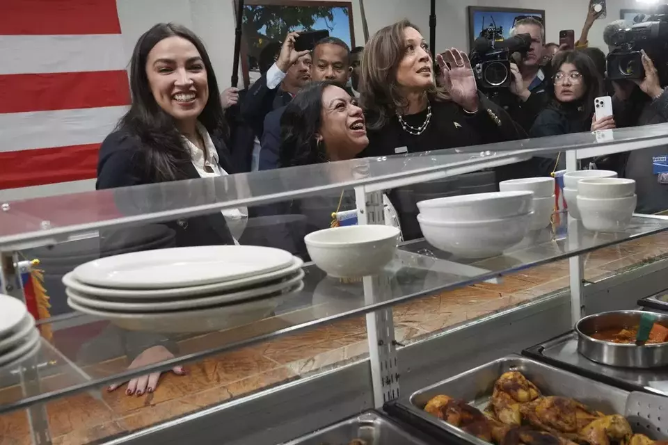 Democratic presidential nominee Vice President Kamala Harris, from right, visits Old San Juan Cafe restaurant with restaurant owner Diana de La Rosa and Representative Alexandria Ocasio-Cortez during a campaign stop in Reading, Pennsylvania, Monday, Nov. 4, 2024. (AP Photo/Jacquelyn Martin)