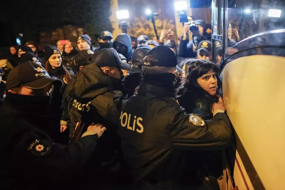 Turkish police officers detain a woman during a protest marking the International Day for the Elimination of Violence Against Women, in Istanbul, Turkey, Monday, Nov. 25, 2024. (AP Photo/Emrah Gurel)