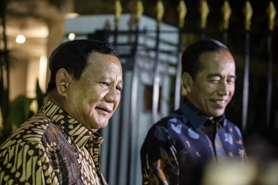 President Prabowo Subianto, left, and his predecessor Joko Widodo speak with journalists at his private residence in South Jakarta, Friday, Dec. 6, 2024. (Antara Photo/Asprilla Dwi Adha)