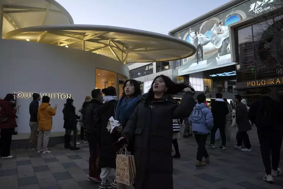 Shoppers visit a popular mall in Beijing, Sunday, Dec. 15, 2024. (AP Photo/Ng Han Guan)