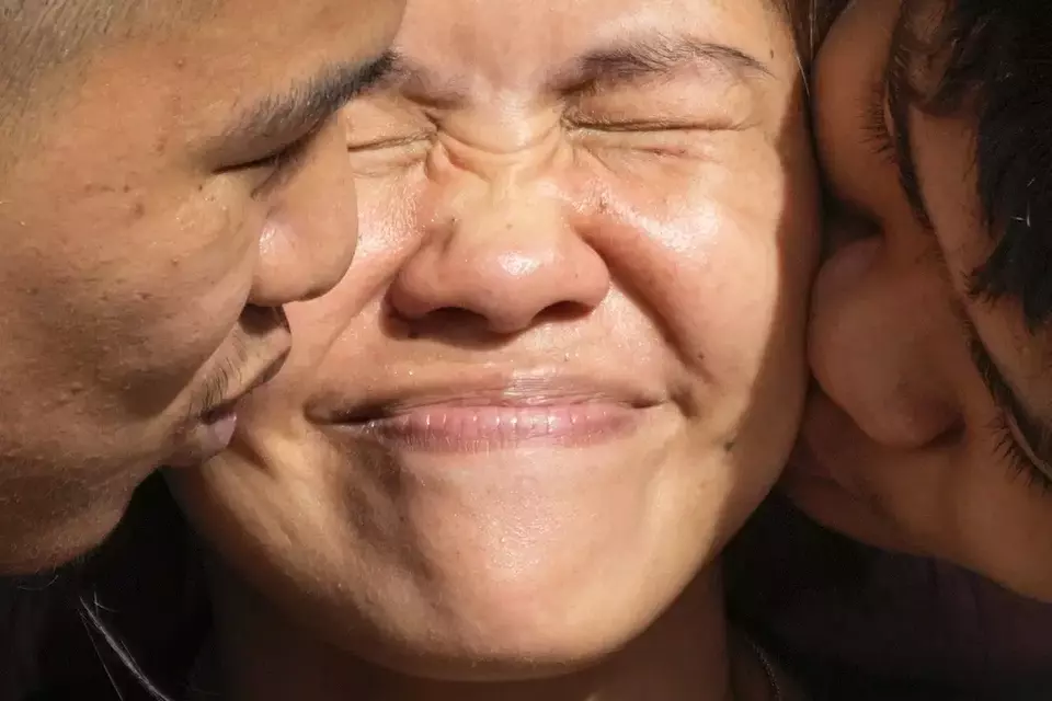 Mary Jane Veloso, center, a Filipino woman who spent almost 15 years in an Indonesian prison for drug trafficking and was nearly executed by firing squad in 2015, is kissed by her sons after being reunited at the Correctional Institution for Women in Mandaluyong, Philippines Wednesday, Dec. 18, 2024. (AP Photo/Aaron Favila)