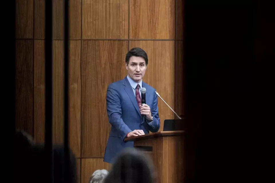 FILE - Canadian Prime Minister Justin Trudeau is pictured through the glass as he speaks with members of his caucus in Ottawa, Ontario, Dec. 16, 2024. (Spencer Colby/The Canadian Press via AP, File)
