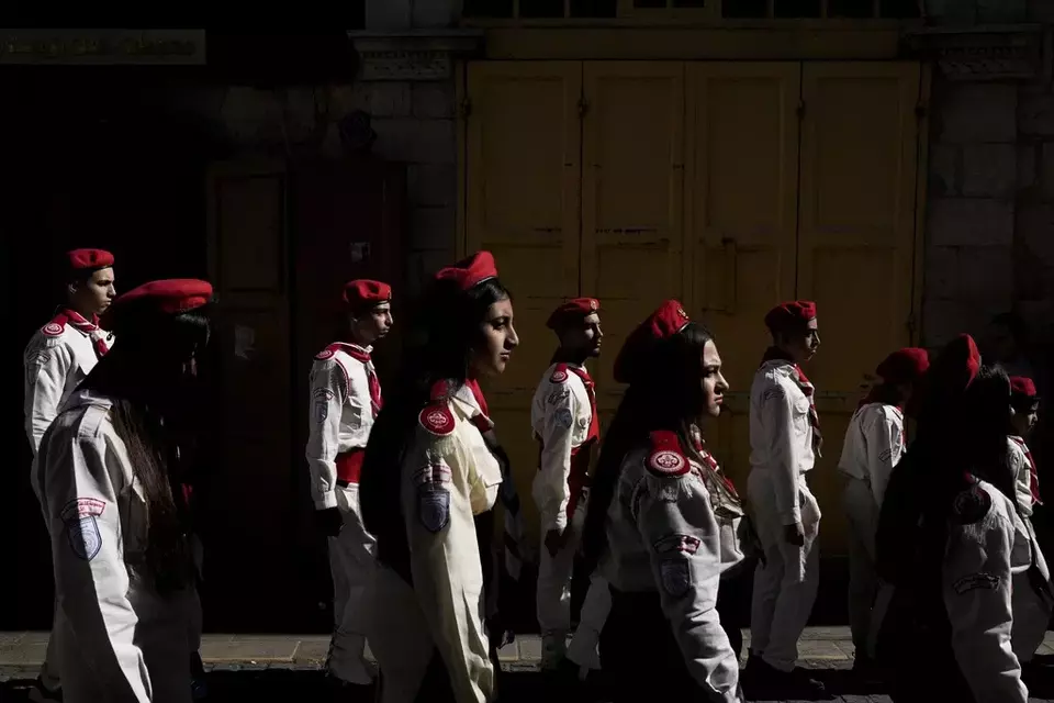 Scouts line up during the traditional Christian procession towards the Church of the Nativity, traditionally believed to be the birthplace of Jesus, on Christmas Eve, in the West Bank city of Bethlehem, Tuesday, Dec. 24, 2024. (AP Photo/Matias Delacroix)