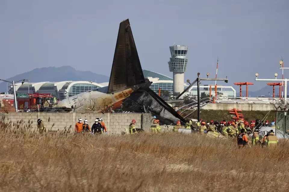 Firefighters and rescue team members work at Muan International Airport in Muan, South Korea, Sunday, Dec. 29, 2024. (Cho Nam-soo/Yonhap via AP