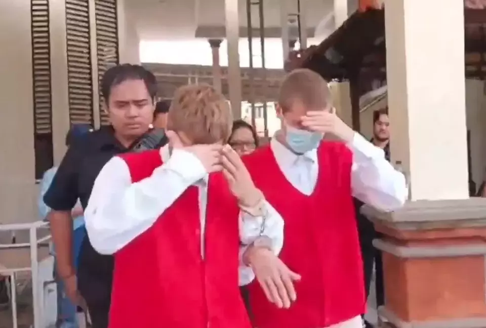 This grab from a video shows Ukrainian brothers Mykyta Volovod, right, and Ivan Volovod arriving at the Denpasar District Court in Bali for their drug trial, Tuesday, Jan. 7, 2025. (Sopian Hadi)