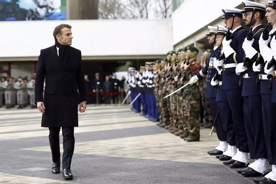 French President Emmanuel Macron reviews the troops during a military ceremony during a visit at the Digital Support and Cyber Command (CATNC) of the French Army as part of his New Year address to the Armed Forces, in Cesson-Sevigne, western France, Monday, Jan. 20, 2025. (Stephane Mahe/Pool via AP)