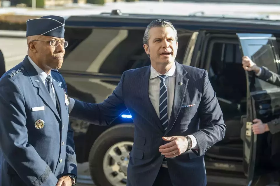 Defense Secretary Pete Hegseth, right, pats Chairman of the Joint Chiefs of Staff Gen. Charles Q. Brown Jr., on his shoulder as he answers questions from reporters after arriving at the Pentagon, Monday, Jan. 27, 2025 in Washington. (AP Photo/Kevin Wolf)

