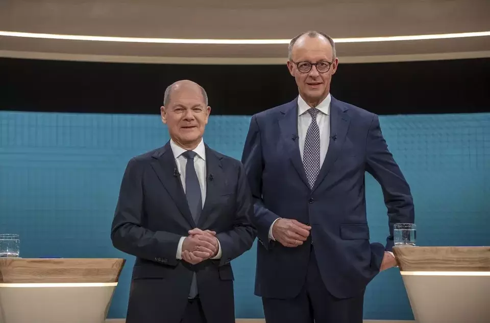 German Chancellor Olaf Scholz, left, and Friedrich Merz, CDU candidate for chancellor before a TV election debate in Berlin, Sunday Feb. 9, 2025. (Michael Kappeler /dpa via AP)