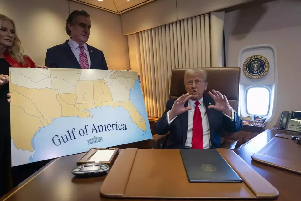 President Donald Trump, right, speaks to reporters accompanied by Interior Secretary Doug Burgum aboard Air Force One where Trump signed a proclamation declaring Feb. 9 "the first ever Gulf of America Day," as he travels from West Palm Beach, Florida, to New Orleans, Sunday, Feb. 9, 2025. (AP Photo/Ben Curtis)
