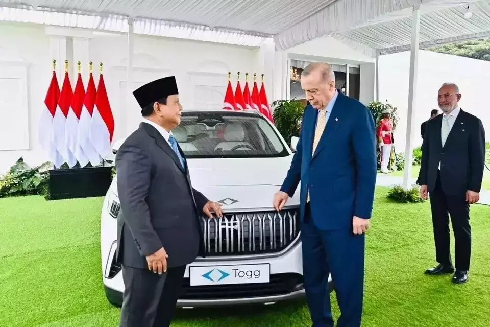 President Prabowo Subianto, left, and visiting Turkish President Recep Tayyip Erdogan pose for a photo in front of the Turkish-made Togg T10X electric vehicle at the Bogor Palace in West Java, Wednesday, Feb. 12, 2025. (Presidential Press Bureau)