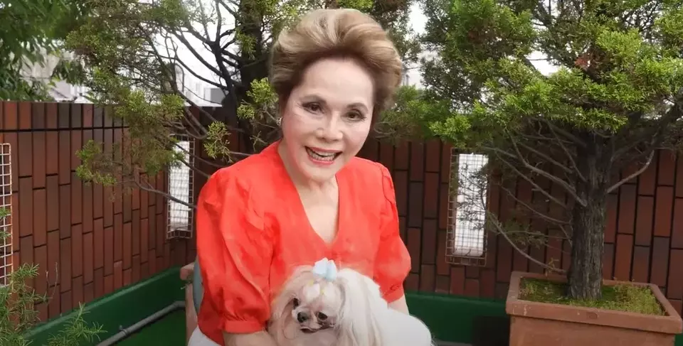 Screen capture of Dewi Soekarno holding her dog. Born as Naoko Nemoto, the 85-year-old former wife of Indonesia's first president, Soekarno, has renounced her Indonesian citizenship and reclaimed her Japanese nationality. (YouTube @Lady.Dewi Channel)