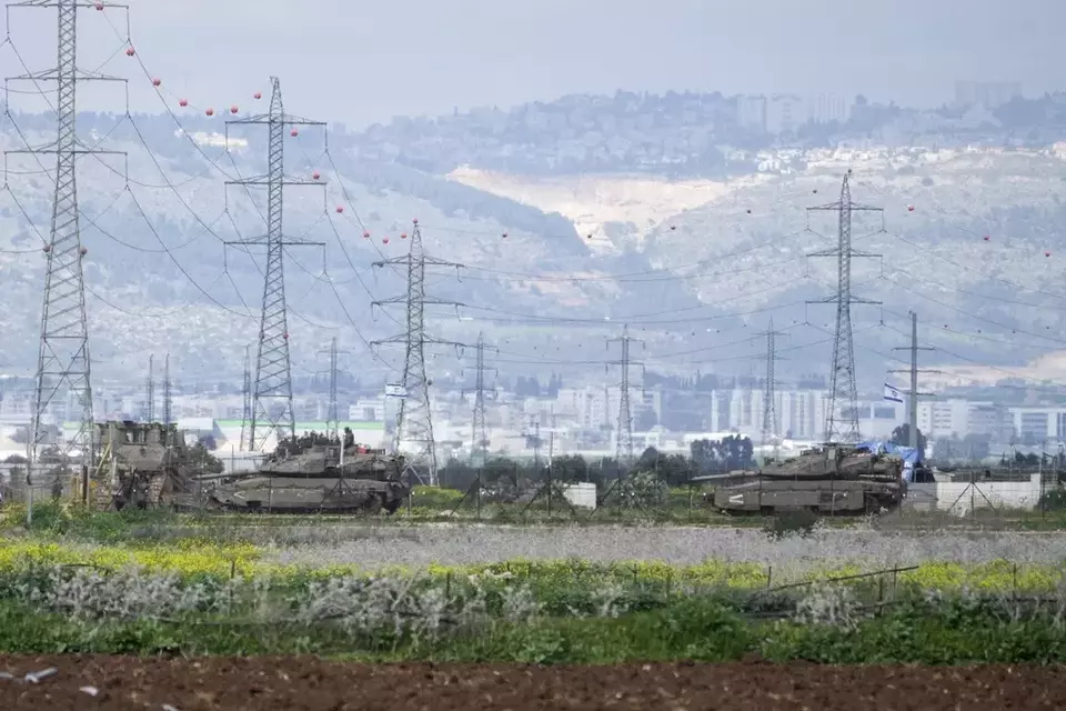 Israeli tanks gather outside of the occupied West Bank near Jenin, Sunday, Feb. 23, 2025. (AP Photo/Majdi Mohammed)