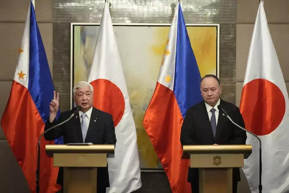 Japanese Defense Minister Gen Nakatani, left, gestures beside Philippine Defense Secretary Gilberto Teodoro during their press conference in Makati city, Philippines on Monday, Feb. 24, 2025. (AP Photo/Aaron Favila)
