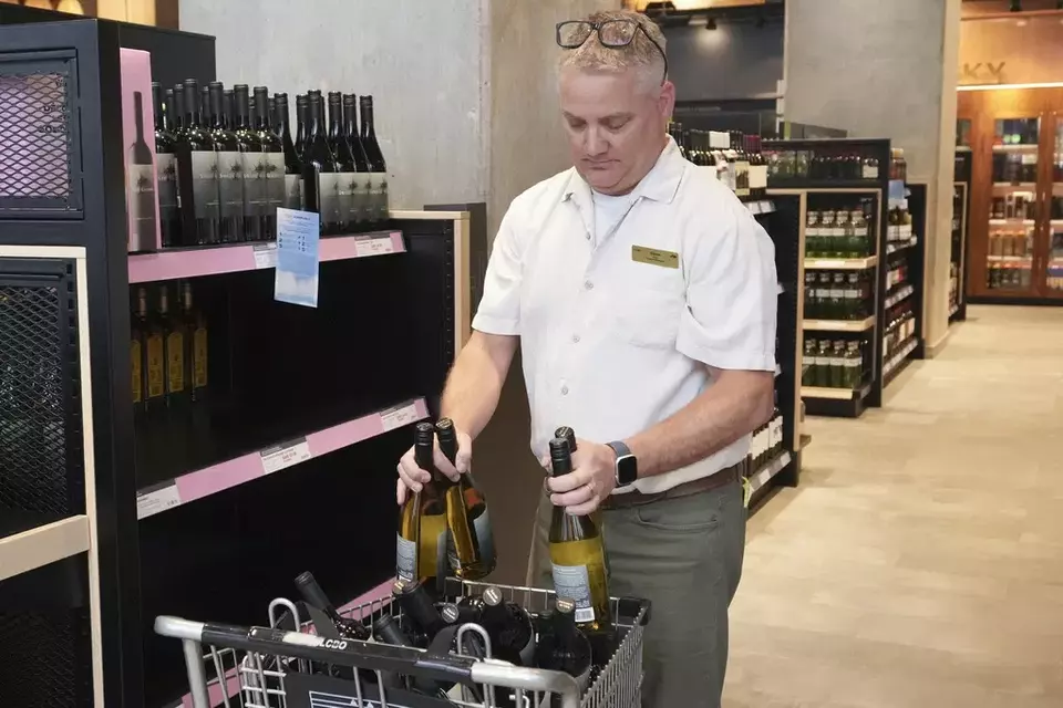 Wine produced in the United States is removed from the shelves of an LCBO store, in response to tariffs imposed on Canadian goods by US President Donald Trump, in Toronto on Tuesday, March 4, 2025. (Chris Young/The Canadian Press via AP)