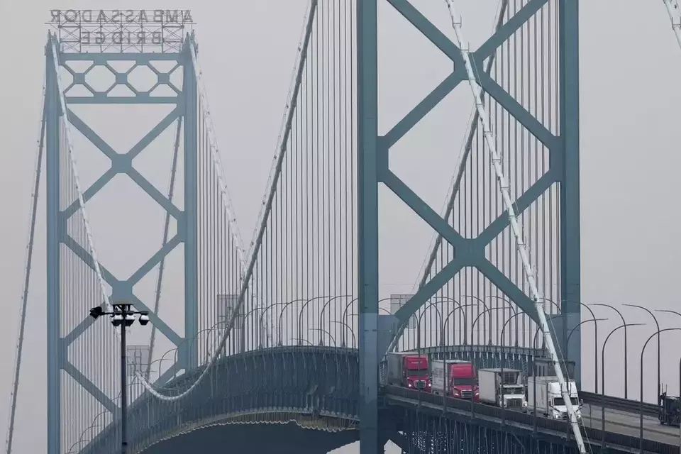 Trucks enter into the United States from Ontario, Canada across the Ambassador Bridge, Monday, Feb. 3, 2025, in Detroit. (AP Photo/Paul Sancya)