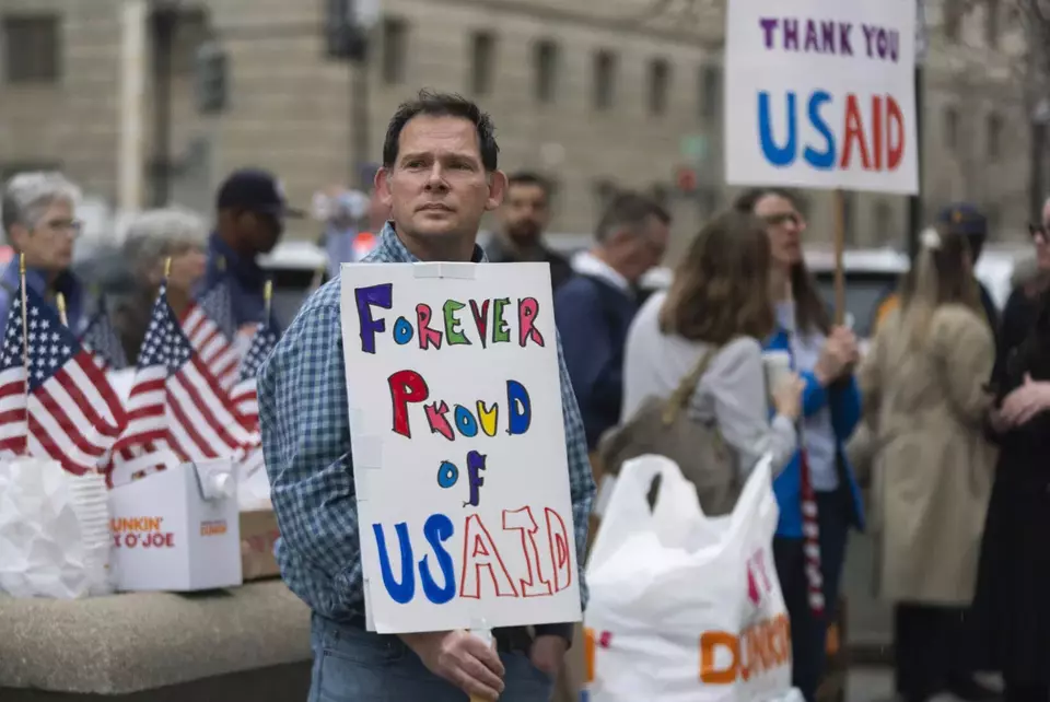 Former US Agency for International Development (USAID) workers show their support to USAID workers retrieving their personal belongings from the agency's headquarters in Washington on Feb. 27, 2025. (AP Photo/Manuel Balce Ceneta)