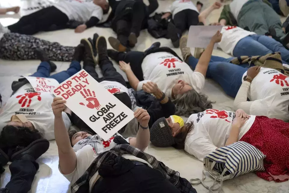 Demonstrators protest against cuts to American foreign aid spending, including USAID and the PEPFAR program to combat HIV/AIDS, at the Cannon House Office Building on Capitol Hill, Feb. 26, 2025, in Washington. (AP Photo/Mark Schiefelbein)