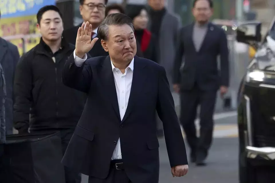 Impeached South Korean President Yoon Suk Yeol waves to his supporters as he comes out of a detention center in Uiwang, South Korea, Saturday, March 8, 2025. (Hong Hyo-shik/Newsis via AP)