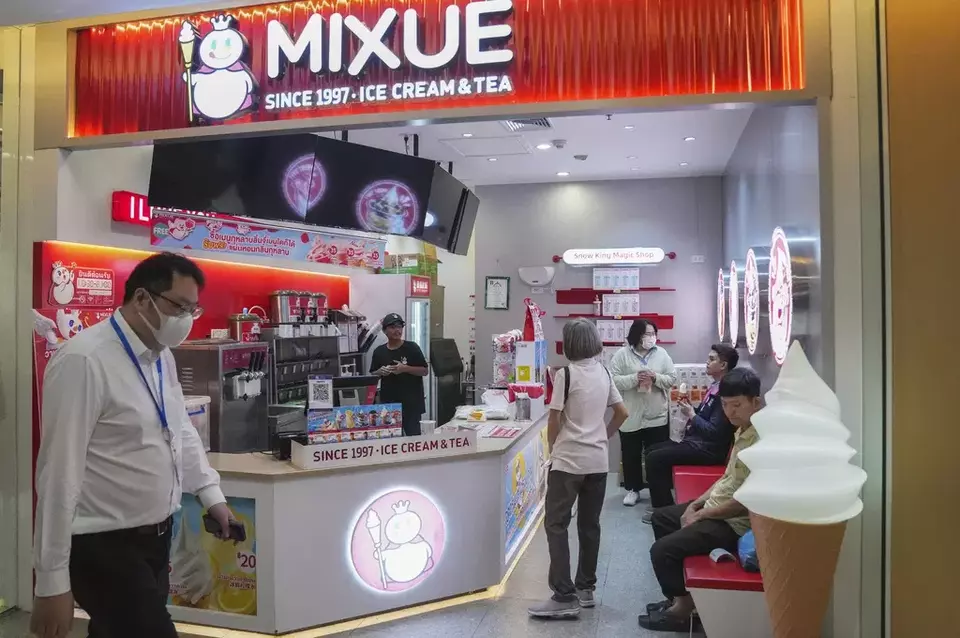 A customer orders an ice cream at Chinese Franchise Mixue ice cream & tea shop in Bangkok, Thailand, Wednesday, Feb. 19, 2025. (AP Photo/Sakchai Lalit)