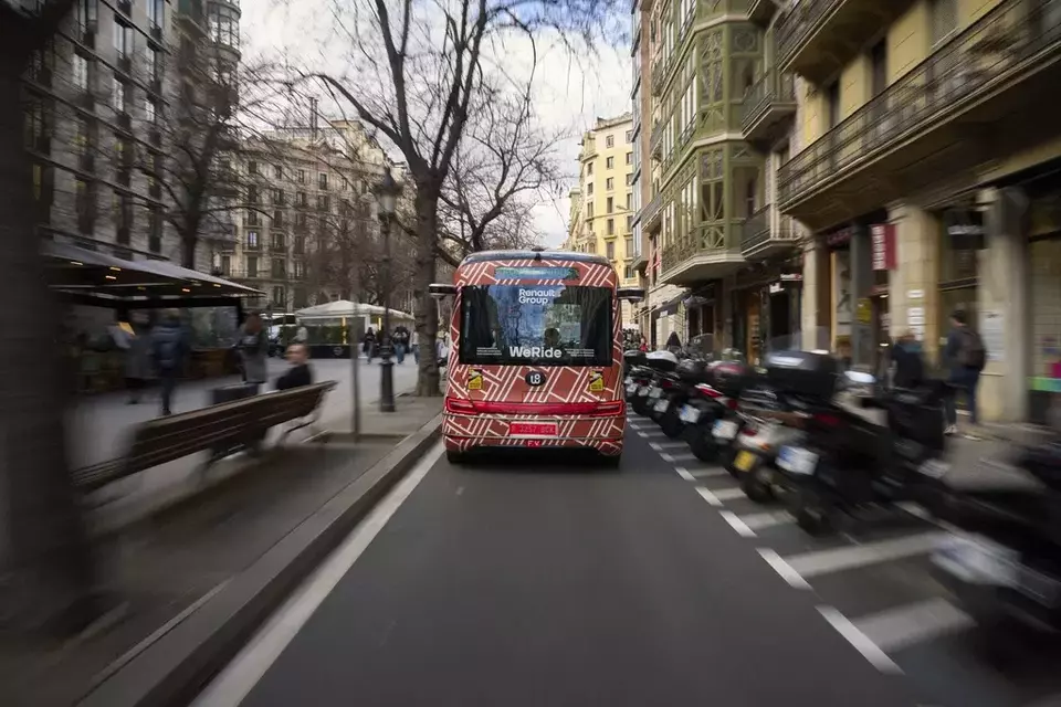 A driverless mini-bus, presented by WeRide and Renault Group, drives along a street in Barcelona downtown, Wednesday, March 12, 2025. Commuters in downtown Barcelona have been able to ride the bus for free this week. There's just one catch: this mini-bus has no one at the wheel. (AP Photo/Emilio Morenatti)