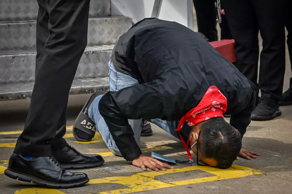 A man kneels upon arrival at Soekarno Hatta International Airport in Tangerang, Banten, on Tuesday, March 18, 2025, after being rescued from an online scam syndicate in Myawaddy, Myanmar. (Antara Photo/Bayu Pratama)