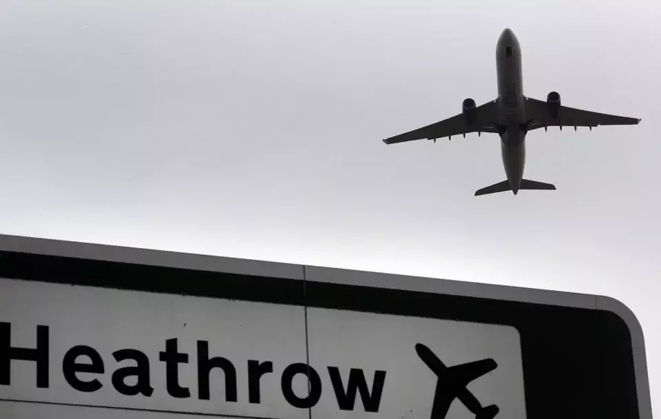 FILE - A plane takes off over a road sign near Heathrow Airport in London, June 5, 2018. (AP Photo/Kirsty Wigglesworth, File)