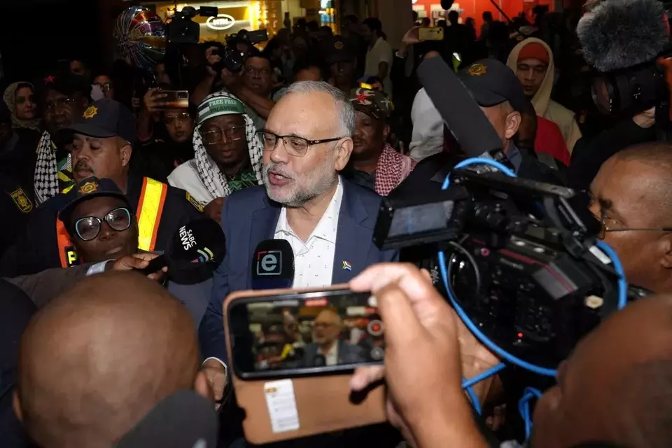 Expelled South Africa Ambassador Ebrahim Rasool speaks to journalists following his arrival, at Cape Town International Airport in Cape Town, South Africa, Sunday, March 23, 2025. (AP Photo/Nardus Engelbrecht)