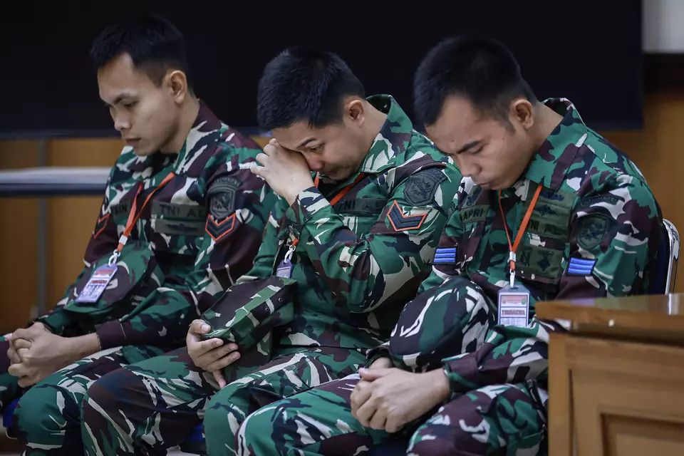 Three sailors, from left: First Sergeant Rafsin Hermawan, First Sergeant Akbar Adli, and Seaman Bambang Apri Atmojo attend their murder trial at a court-martial in Jakarta, Monday, March 17, 2025. (Antara Photo/Dhemas Reviyanto)