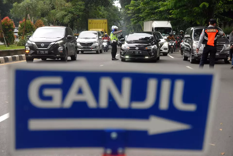 The sign reads "ganjil" or "odd" in Indonesian. This undated photo is an illustration of the odd-even traffic rule in Jakarta. (Antara Photo)