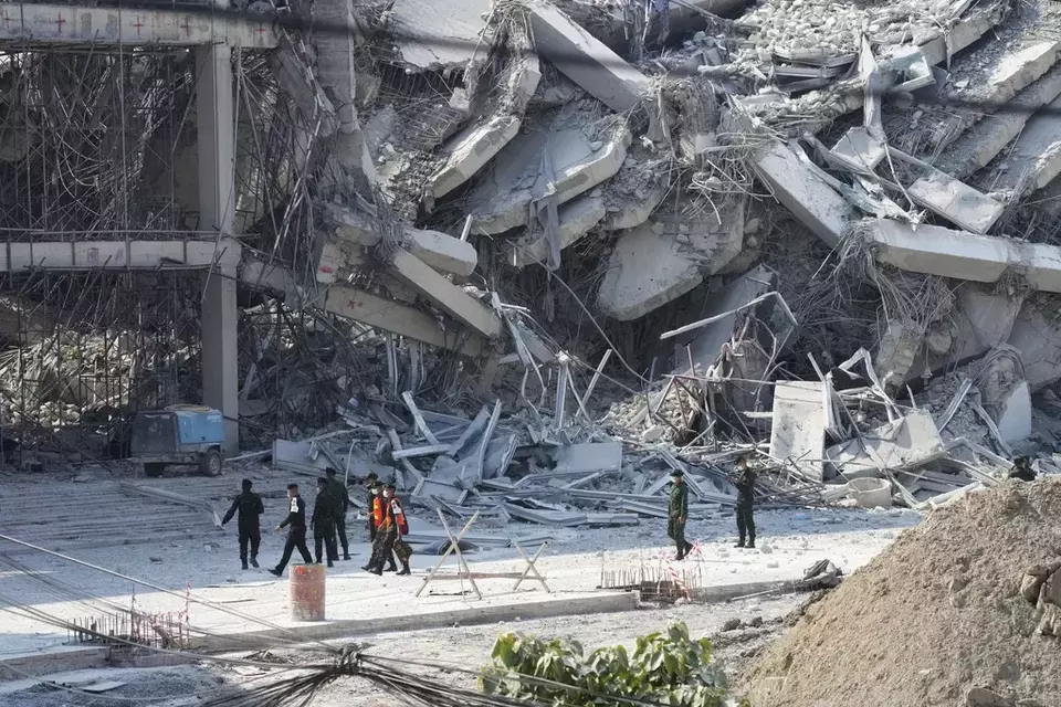 Rescuers walk at the site of a high-rise building under construction that collapsed after a 7.7 magnitude earthquake in Bangkok, Thailand, Friday, March 28, 2025. (AP Photo/Sakchai Lalit)