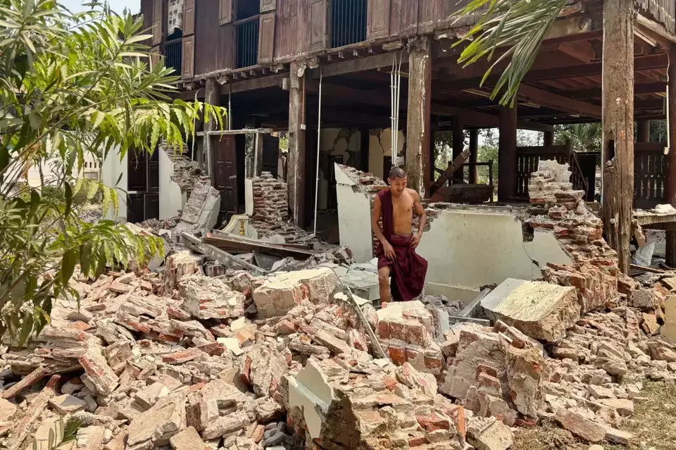 A Buddhist monk walks near a damaged building at a monastery compound after an earthquake on March 28, 2025 in Naypitaw, Myanmar. (AP Photo/Aung Shine Oo)