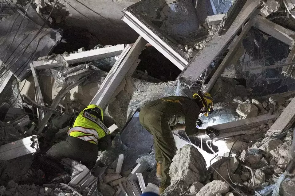 Rescuers search for victims at the site of a high-rise building under construction that collapsed after a strong earthquake in Bangkok, Thailand, early Saturday, March 29, 2025. (AP Photo/Wason Wanichakorn)

