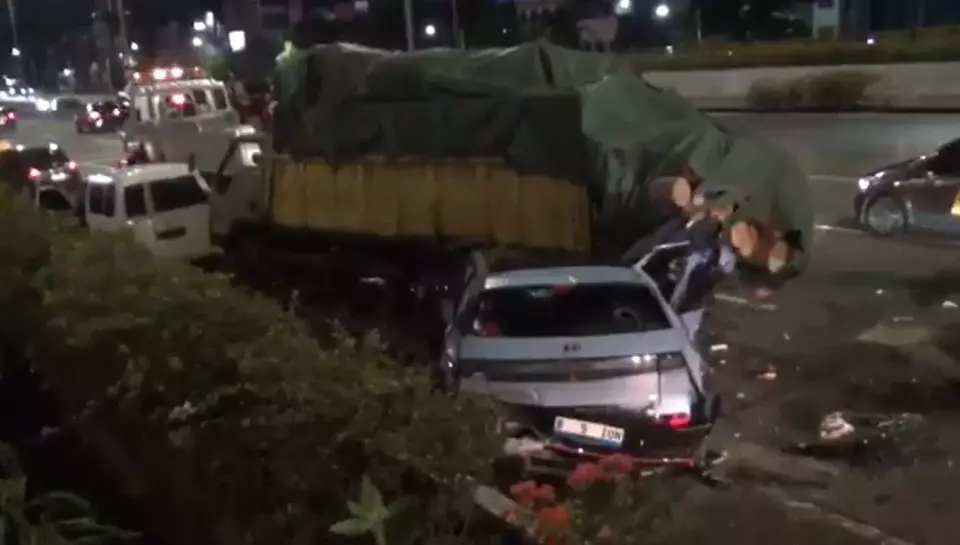 The wreckage of a Hyundai electric car is seen after colliding with a truck carrying logs along the West Jakarta toll road, Saturday, March 29, 2025. (Videography/Taufik Hudayat)