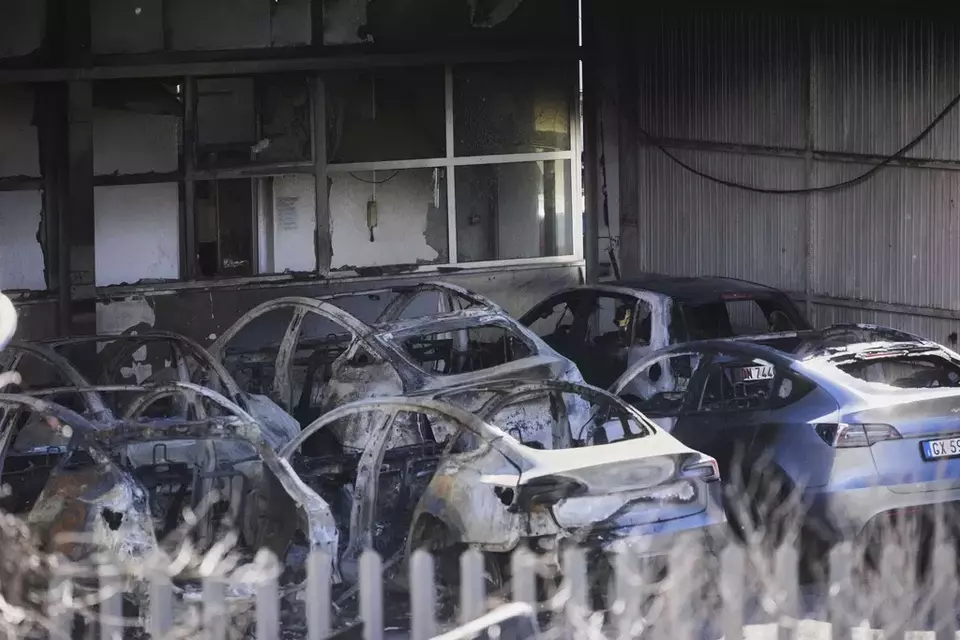 Burned Tesla cars are seen at a dealership on the outskirts of Rome, Monday, March 31, 2025. (AP Photo/Alessandra Tarantino)