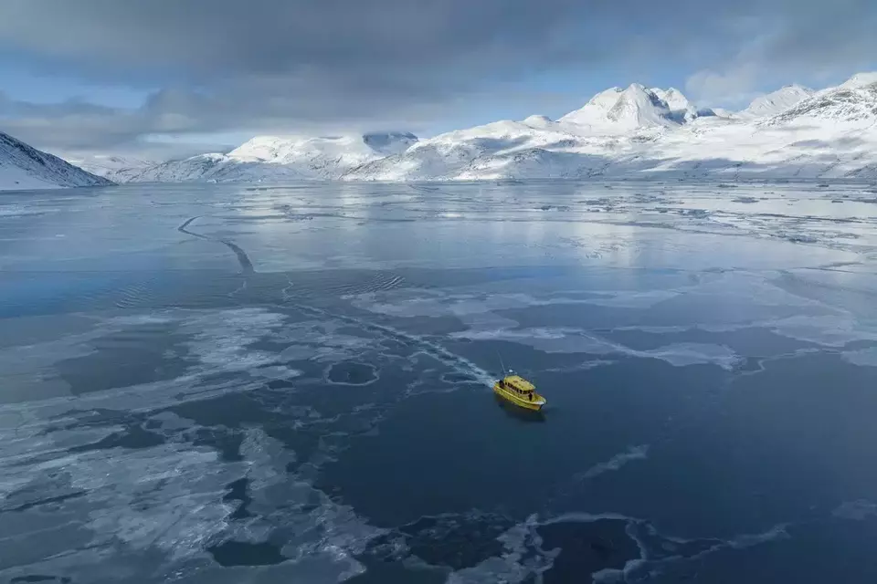 A boat rides through a frozen sea inlet outside of Nuuk, Greenland, March 6, 2025. (AP Photo/Evgeniy Maloletka)