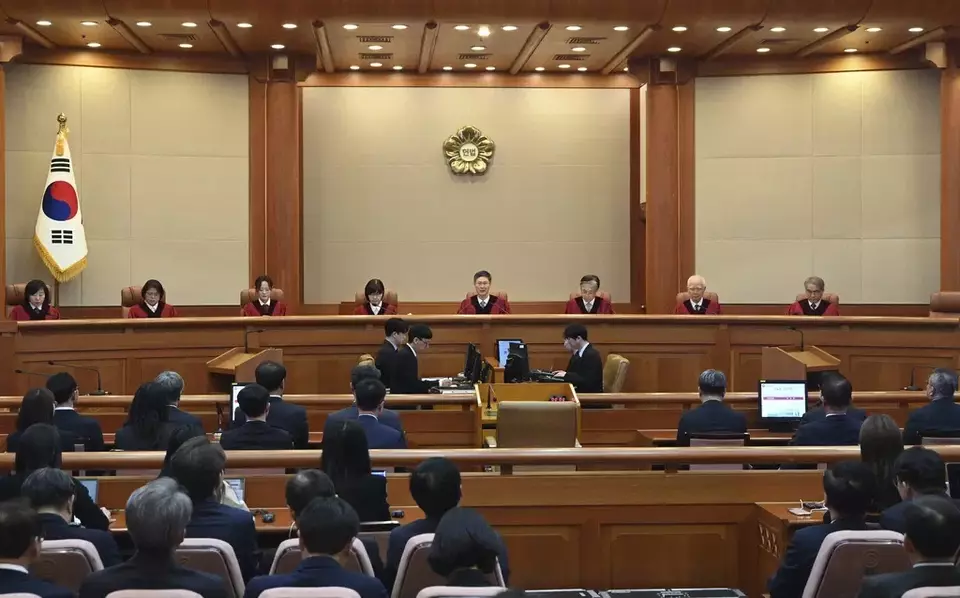 Moon Hyung-bae, center, acting chief justice of South Korea's Constitutional Court, speaks during the final ruling of South Korean President Yoon Suk Yeol's impeachment at the Constitutional Court on Friday, April 4, 2025 in Seoul, South Korea. (Kim Min-Hee, Japan Pool/Kyodo News via AP)