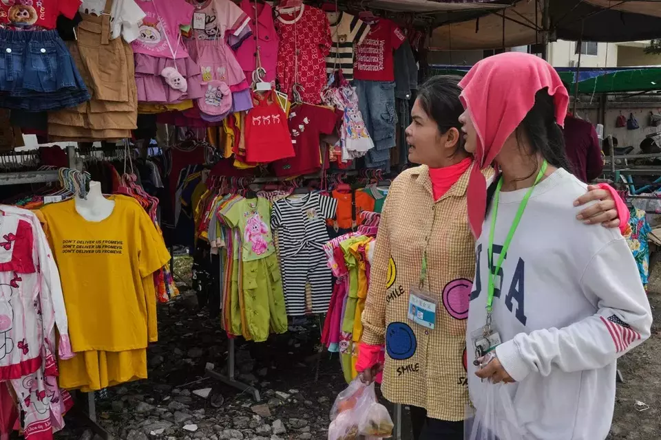 Women shop for clothes at a garments market in Dhaka, Bangladesh, Thursday, April 3, 2025. (AP Photo/Mahmud Hossain Opu)