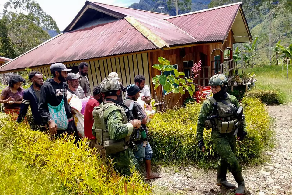 FILE - Indonesian security officers visit a house in Anggruk District, Yahukimo Regency, Papua, to evacuate victims after an attack by a militia group, Sunday, March 23, 2025. (Photo courtesy of the Indonesian Army)